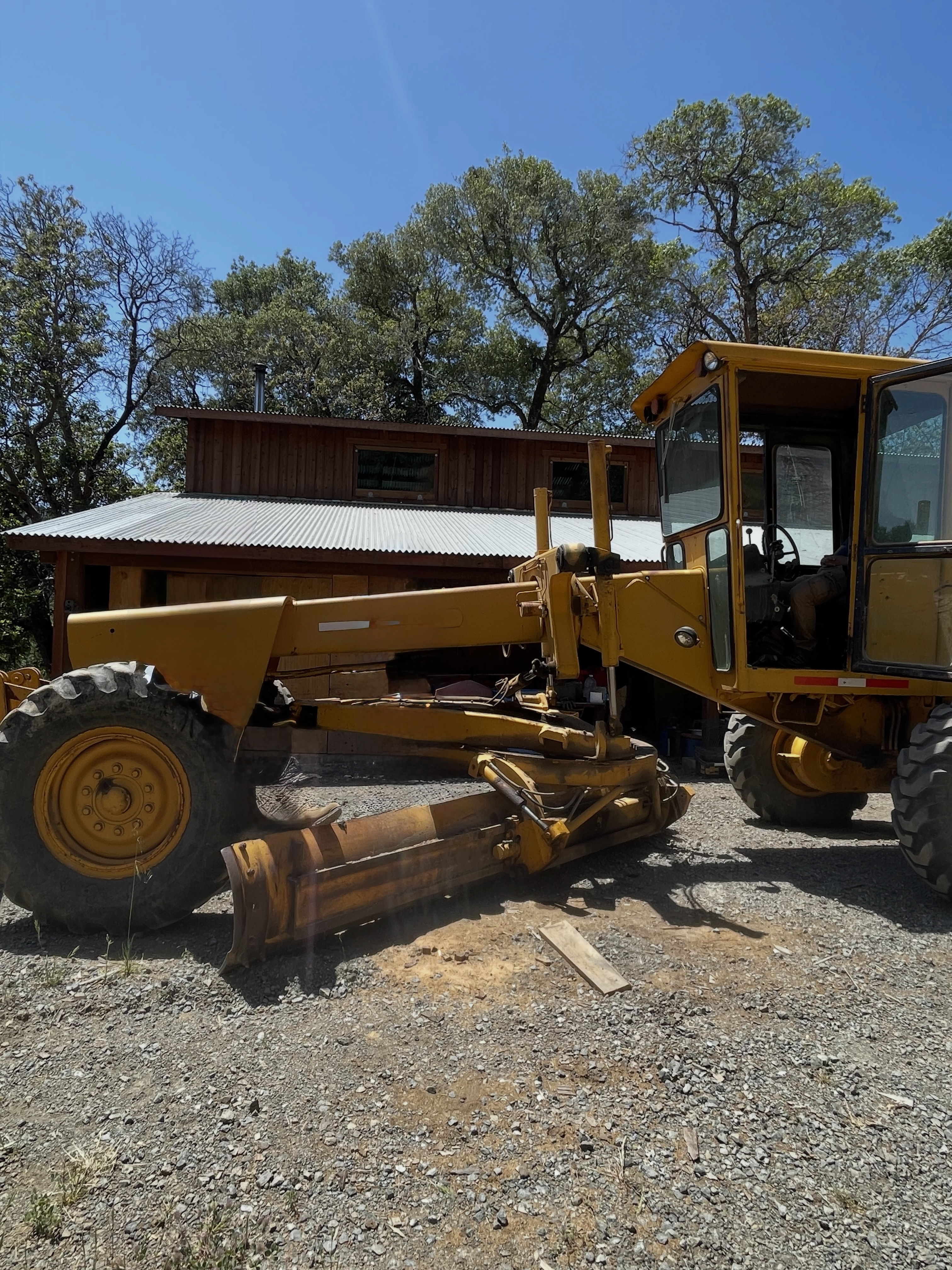 Grader working on a sloped yard in Northern California